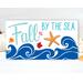This whimsical autumn-themed coastal sign with bright blue waves, fall leaves, and an orange resin starfish for your coastal fall decor.